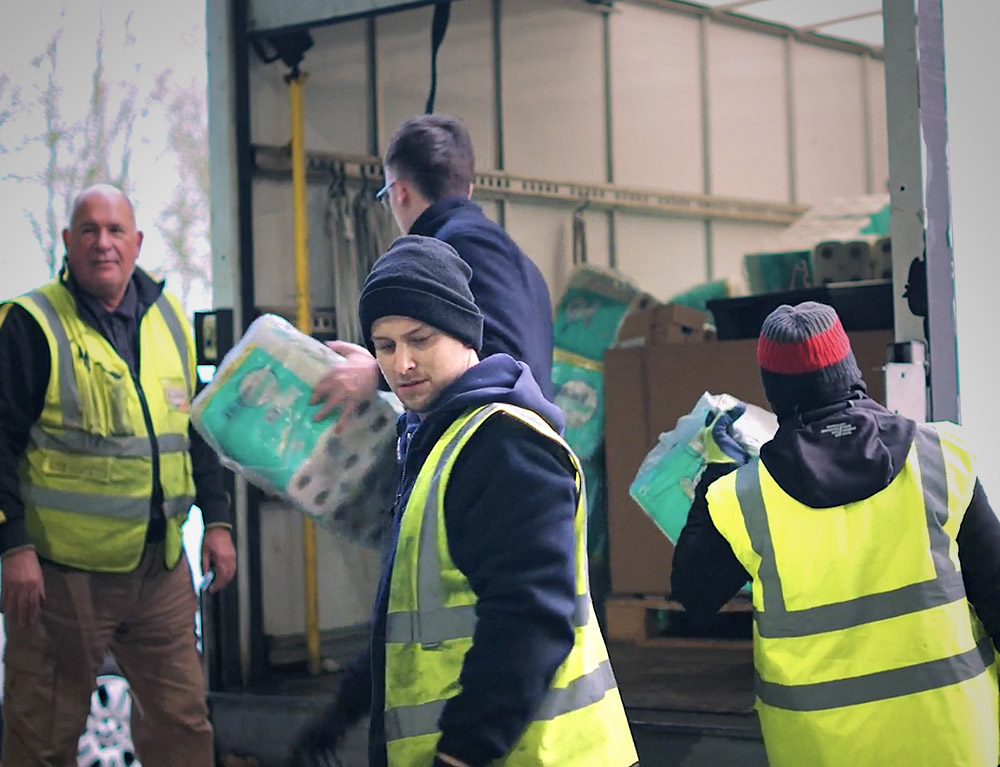 Multibank Scotland team members loading donated goods into a van